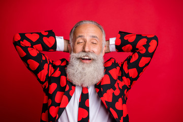 Sticker - Photo of funky positive aged handsome man amour role at party eyes closed hold hands behind head wear hipster hearts pattern suit blazer tie isolated red color background