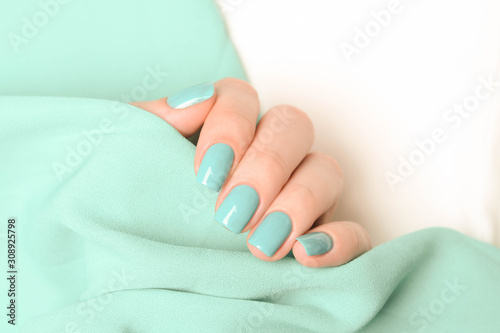 manicure in mint color on the white mint background Lerretsbilde