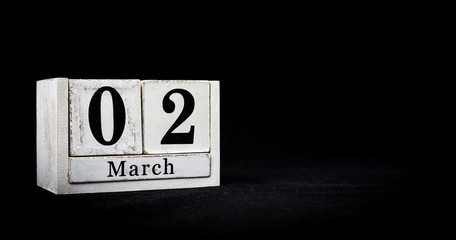 March 2nd, Second of March, Day 2 of month March - white calendar blocks on black textured background with empty space for text.