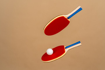 Wall Mural - Two table tennis rackets on beige background