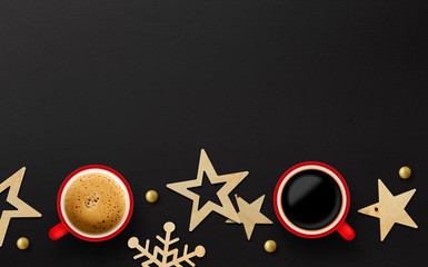 two red cup of coffee and christmas decoration on black paper background