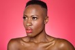 © MDBPIXS - Close up of serious African American woman over colored background