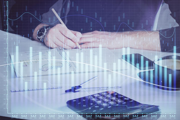 Double exposure of man doing analysis of stock market with forex graph.