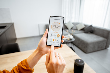 controlling home heating temperature with a smart home, close-up on phone. concept of a smart home a
