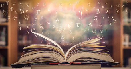 Poster - The concept of education by planting a tree of knowledge in the opening of an old book in the library and the magical magic of light that flies to the destination of success. Beautiful background