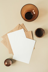 Wall Mural - Blank paper sheets with empty copy space for text, envelopes, hydrangea flower on beige background. Flat lay, top view mail letter invitation.