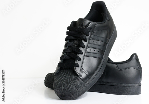 black adidas shell toe trainers