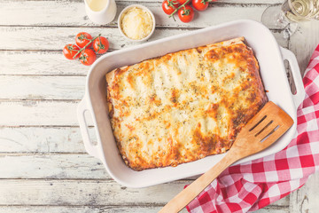 Poster - Traditional italian lasagna with vegetables, minced meat and cheese. On a wooden background. Top view, copy space