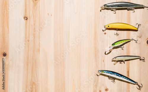 Cuadros en Lienzo Fishing tackle - fishing spinning, hooks and lures on wooden background