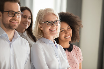 Diverse smiling team posing for group picture together