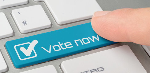 Wall Mural - a keyboard with a blue labeled button - vote now
