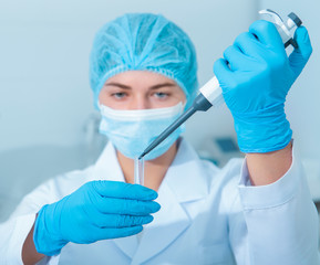 Poster - Young scientist drops samples from pipete to test tubes