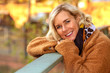 © wernerimages - blond woman in her 40s outdoors enjoying the autumn sun