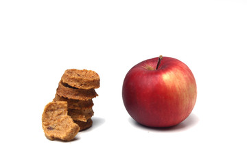 red apple and a pile of fruit candies isolated on white background