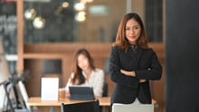 Confidently  Asian Businesswoman Standing On Front Of Office Workplace.