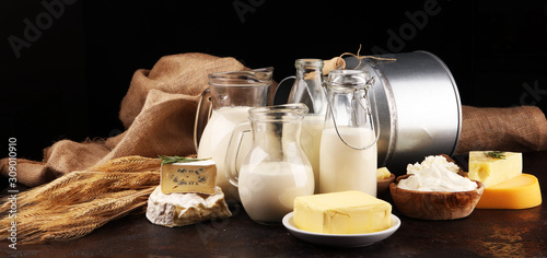 Fotomural Different healthy dairy products on rustic background with milk, cheese, butter