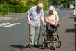Elderly Couple with Walking Frame and Stick on the Sidewalk