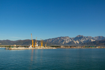 Italy, Tuscany: view of the port in Marina di Carrara and in the background the Apuan Alps with the marble quarries