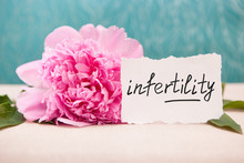Infertility - Lettering On Card With Peony Flower On Blue, Woman Sickness About Pregnancy