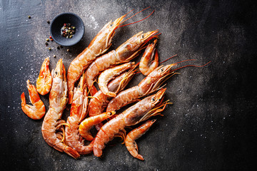 Raw giant shrimps on dark table