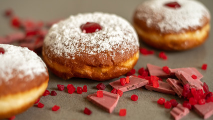 Wall Mural - Hanukkah background with fresh donuts and pink ruby chocolate.