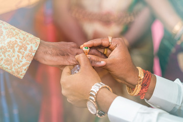 man putting ring to another man indian wedding