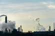 © Pokoman - Chemical industry. Environmental pollution by harmful emissions into the atmosphere. Poisonous smoke comes from the big pipes. The factory poisons nature. Silhouette of pipes and smoke. Sunny day.