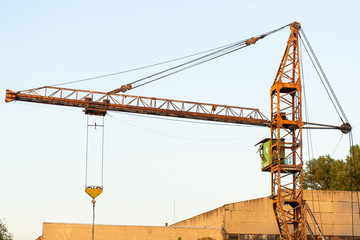 Old rusty construction crane at a construction site.