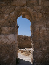 Stone Wall With An Arch Inside Of Roman Ruins Of The Citadel Of Amman, Capitol Of Jordan, Remains Of A City Build From Stone And Tall Pillars On A Brown Hill In The Middle Of A City