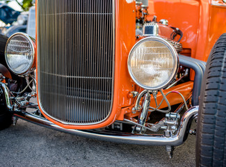 Wall Mural - Epic vintage orange retro car with open wheel suspension and headlights on the sides of the car body