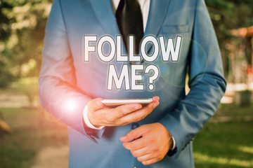 Fototapete - Conceptual hand writing showing Follow Me Question. Concept meaning go or come after demonstrating or thing proceeding ahead Businessman in blue suite stands with mobile phone in hands