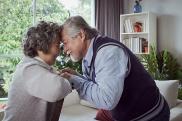 Wall Mural - Happy couple old elderly senior man and woman hugging and touch with forehead, happy with smiling together at home, retirement and healthcare lifestyle and lover relationship concept