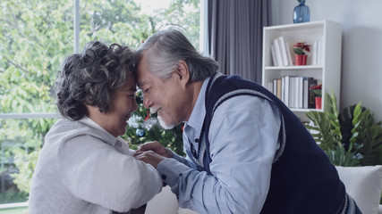 Wall Mural - Happy couple old elderly senior man and woman hugging and touch with forehead, happy with smiling together at home, retirement and healthcare lifestyle and lover relationship concept