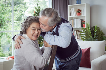 Wall Mural - Happy couple old elderly senior man and woman hugging and touch with forehead, happy with smiling together at home, retirement and healthcare lifestyle and lover relationship concept