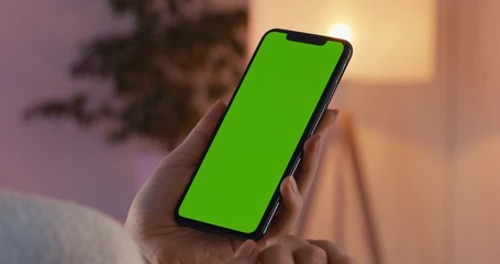 green screen chroma key cu caucasian female using generic smart phone, vertical orientation, modern 