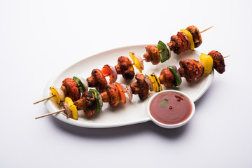 Canvas Print - Barbecue or tandoori Mushroom Tikka, served in a plate with green chutney and ketchup. selective focus