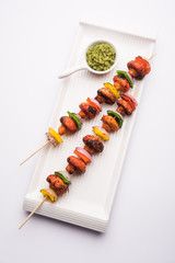 Canvas Print - Barbecue or tandoori Mushroom Tikka, served in a plate with green chutney and ketchup. selective focus