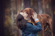 Happy young woman embracing a dog.