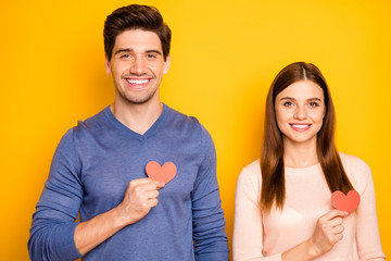 Sticker - Close up photo of dreamy two people spouses celebrate 14-february hold small red paper card hearts show passionate love feelings wear good look clothes isolated yellow color background