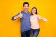 © deagreez - Portrait of two married people promoters hug embrace recommend advise discounts choice decision show thumb up sign wear blue pink sweater isolated over vivid color background
