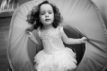 Little Girl Crawls Inside Toy Tunnel At Childrens Holiday. Black White Photo