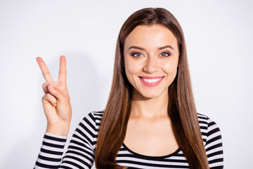 Poster - Close up photo of lovely lady making v-sign with toothy smile wearing striped pullover isolated over white background