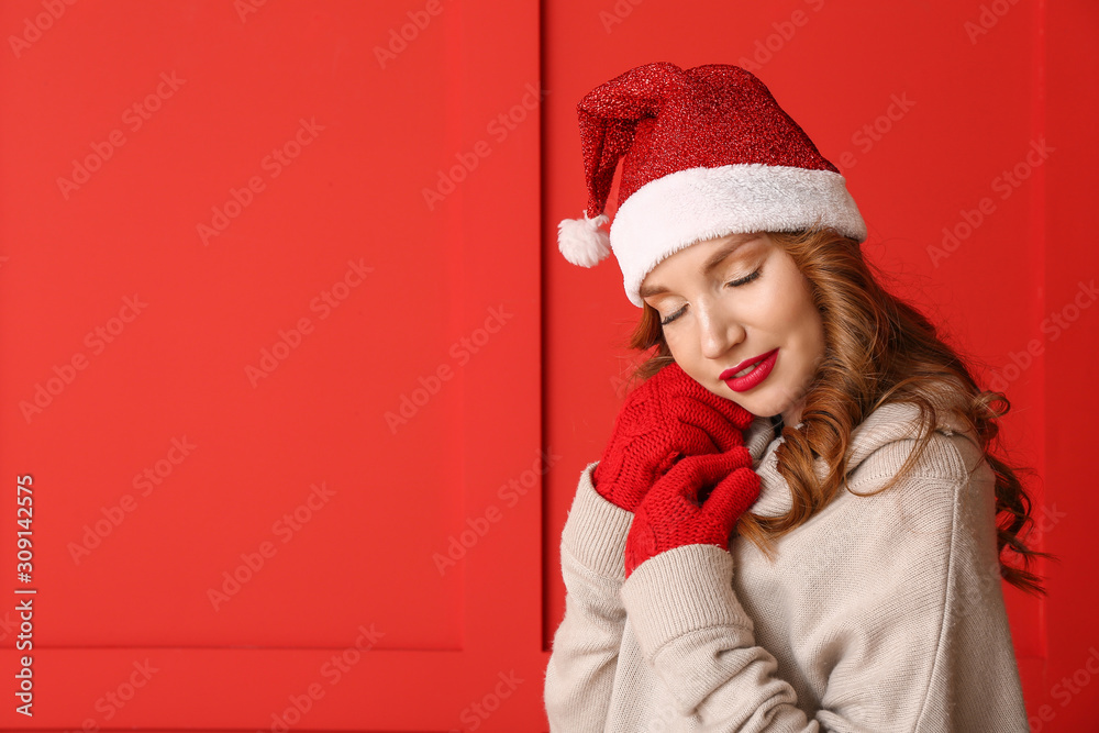 Young woman in winter clothes on color background
