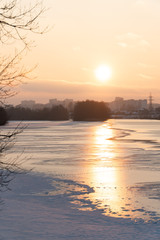 Canvas Print - sunset over a river covered in ice and snow