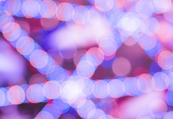 Wall Mural - Electric multi-colored garlands. Light colored spots. Festive background, blurred image.