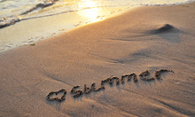 The Word Summer Written On Sand.