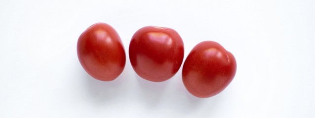 three small red tomatoes isolated on white background banner long horizontal