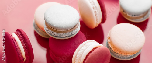 Cuadros en Lienzo French macaroons on wine red background, parisian chic cafe dessert, sweet food
