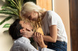 © LIGHTFIELD STUDIOS - Side view of smiling blonde girl touching boyfriend face at home