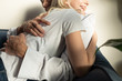 © LIGHTFIELD STUDIOS - Cropped view of smiling blonde girl hugging boyfriend on sofa